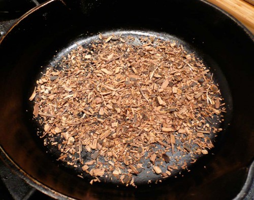 Toasting shredded sarsaparilla root to release its oils